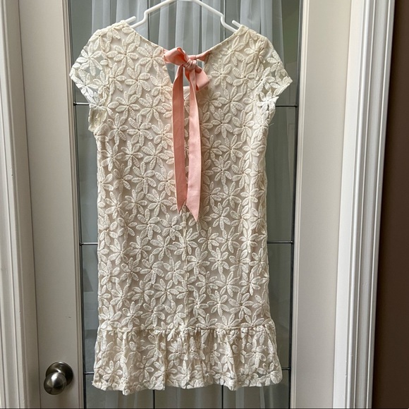 Beautiful and cute lace dress with peach bow on the back. - Picture 3 of 4